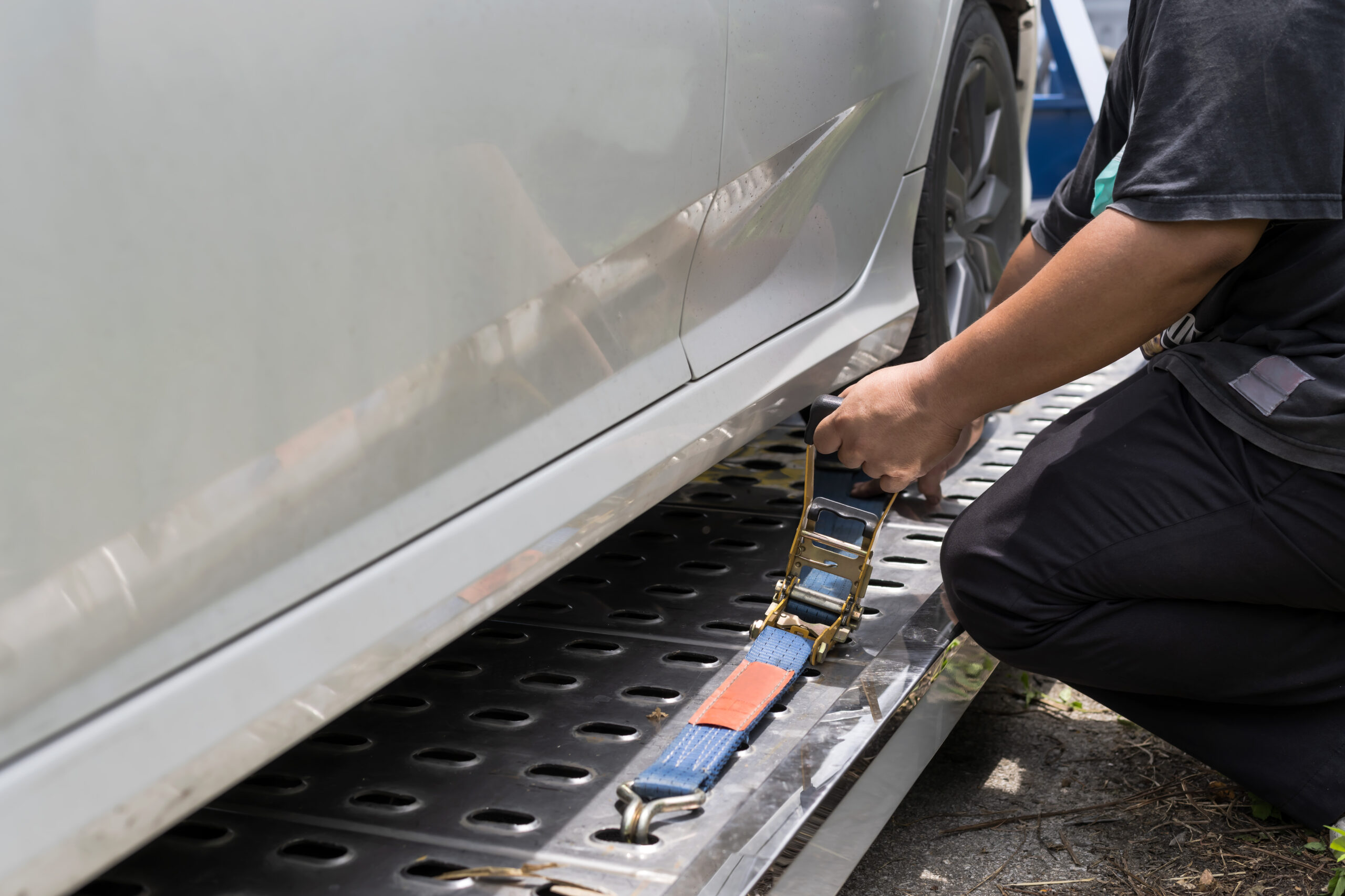 Towing Man Locking Car On Towing Truck