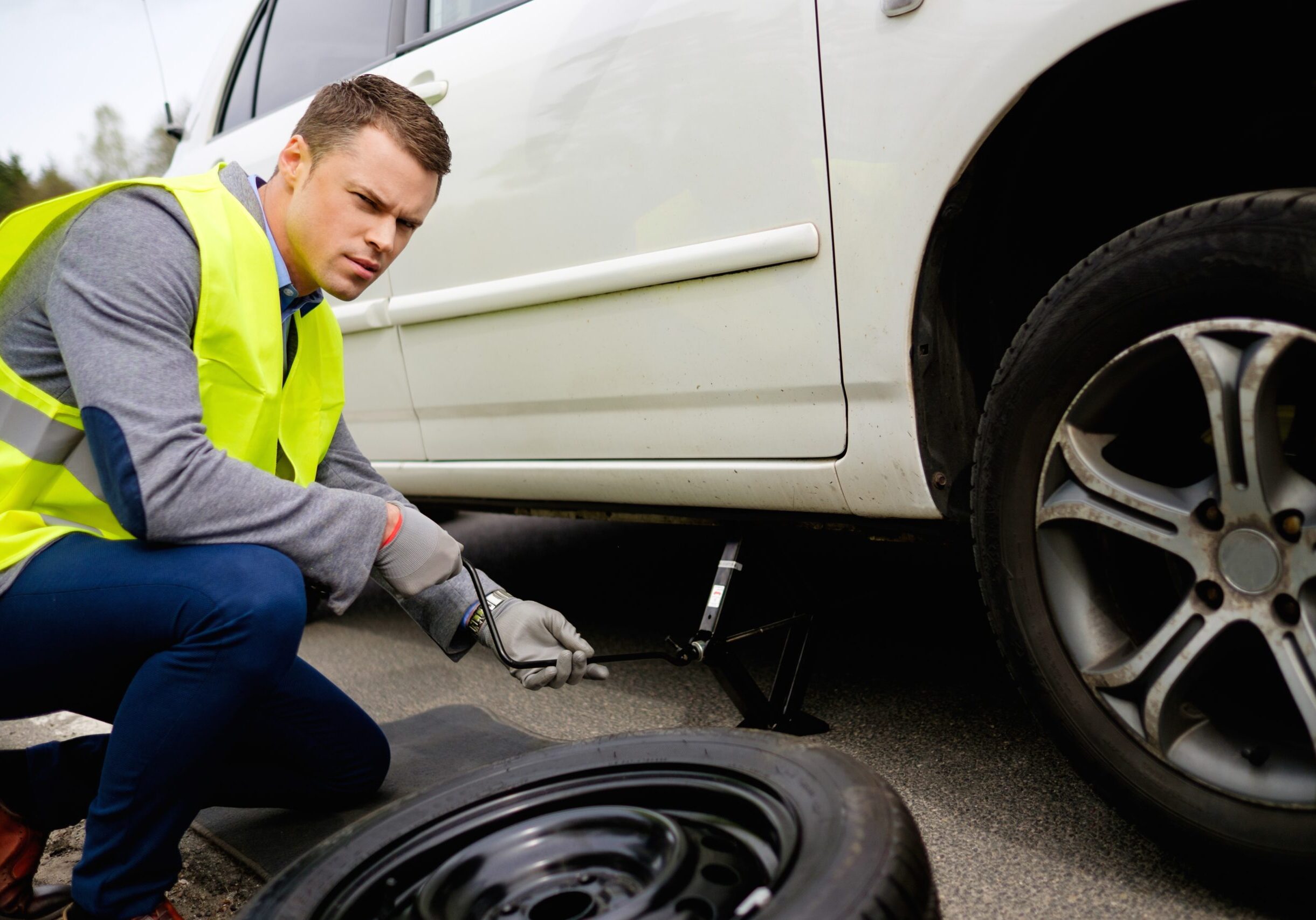 Man Changing Wheel On A Roadside